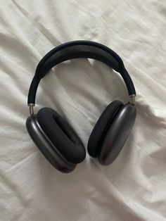 the headphones are on top of the white sheet