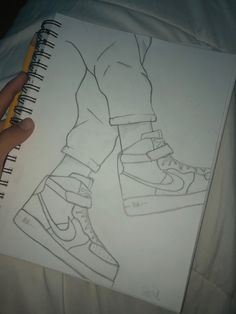 a drawing of a person's feet with shoes on them and a pencil in their hand