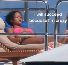 a woman laying on top of a beach chair next to another person in the water