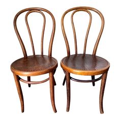 two wooden chairs sitting side by side