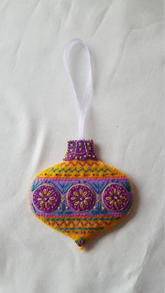 a colorful ornament hanging from a white cloth