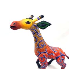 a colorful giraffe figurine on a white background