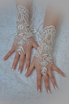 two hands with white lace and flowers on them