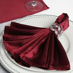 the napkins on the plate have been folded to look like they are holding wine glasses