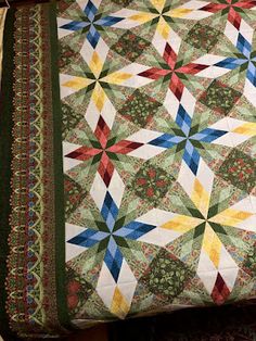 a quilted table topper with an intricate design on it