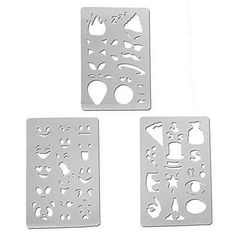 three pieces of metal cutouts with different shapes and sizes on them, one is white