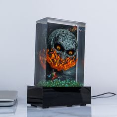 a glass block with an image of a skull on it and flames coming out of its mouth