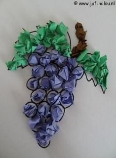 a bunch of grapes that are made out of paper