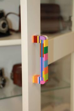 a wooden letter made out of colored blocks