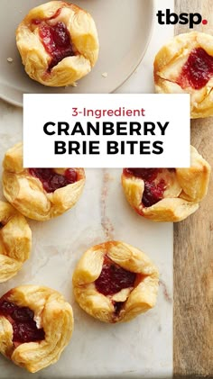 three ingredient cranberry brie bites on a white plate with the words 3 ingredient cranberry brie bites