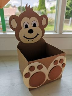 a cardboard box that has a monkey in it