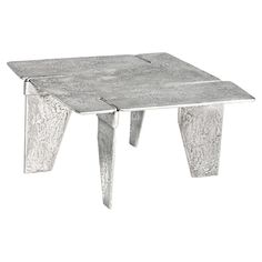 a small metal table with two legs and one foot on the top, sitting against a white background