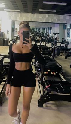 a woman taking a selfie in a gym