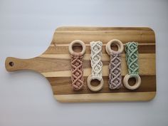 four wooden rings are tied together on a cutting board