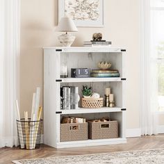 a white book shelf with baskets and books