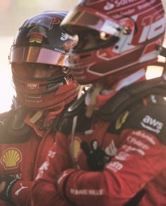 a man wearing a red racing suit and helmet