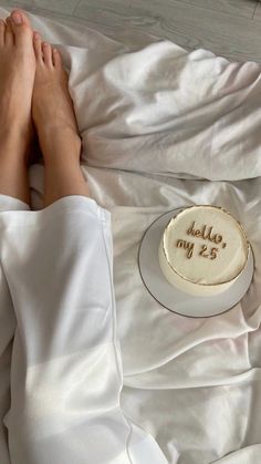 a person laying in bed next to a cake