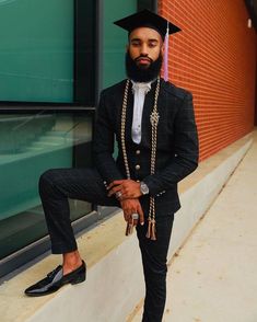 a man in a suit and tie with a beard wearing a tassel around his neck