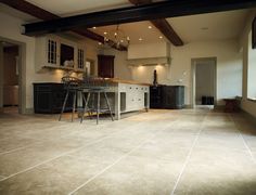 a large kitchen with two bar stools in it