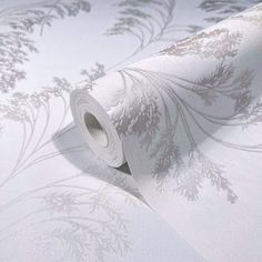 a roll of white wallpaper with silver flowers on it