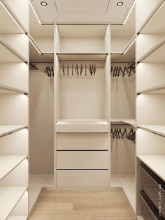 an empty walk in closet with lots of white shelves