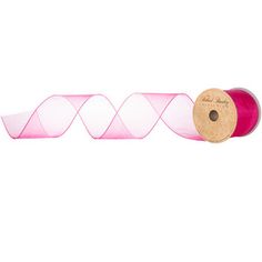 a roll of pink organine ribbon on a white background with a wooden spool