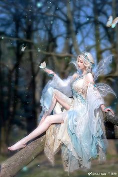 a fairy sitting on top of a tree branch