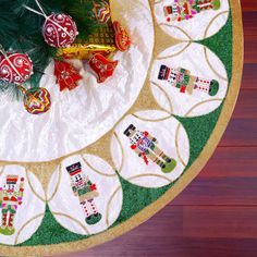 a christmas tree skirt with ornaments on it