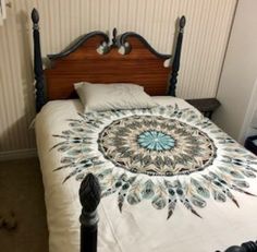 a bed with a white bedspread and blue accents on the headboard is shown