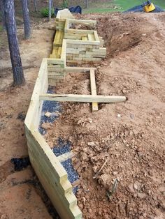 a wooden fence laying on top of a dirt field