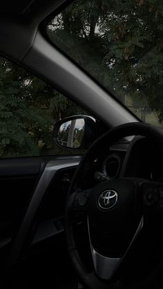 the interior of a car with trees in the background