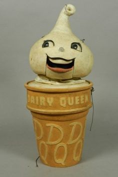 an odd looking toy sitting on top of a pot with the word airy queen written on it