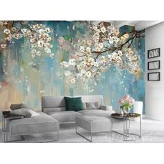 a living room with white furniture and flowers on the wall, painted in shades of blue