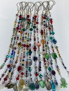 a bunch of different colored beads hanging from hooks