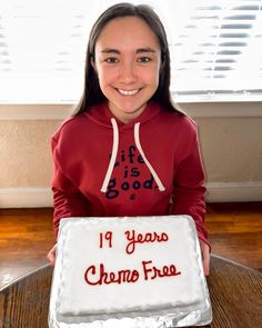 a woman holding a cake that says it is good