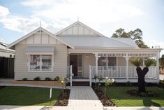 a small white house with a front porch