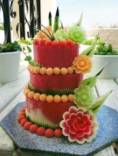 there is a watermelon cake with flowers on it