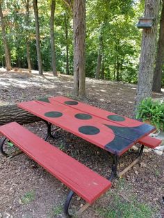 a red picnic table with black polka dots on it