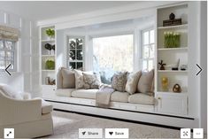 a living room filled with lots of white furniture