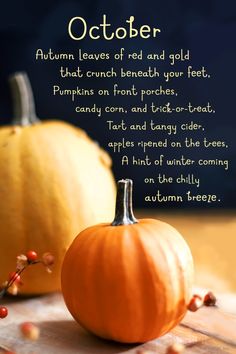 two orange pumpkins sitting on top of a wooden table next to an autumn poem