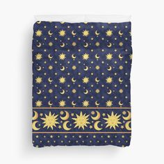 a blue and gold bed with stars and moon pattern on the side, in front of a white background