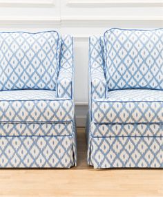 two blue and white chairs sitting next to each other