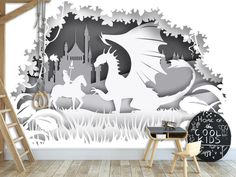 a room with a white wall and black and white paper cut art