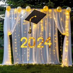 a graduation decoration with balloons and lights