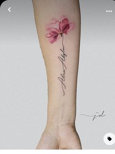 a woman's arm with a pink flower on it