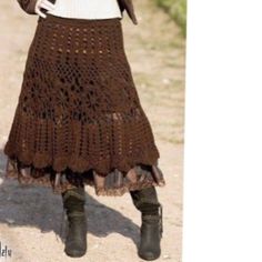 a woman wearing a brown crochet skirt and jacket