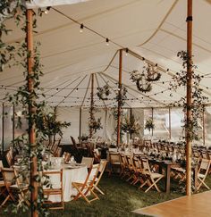 an outdoor tent set up with tables and chairs