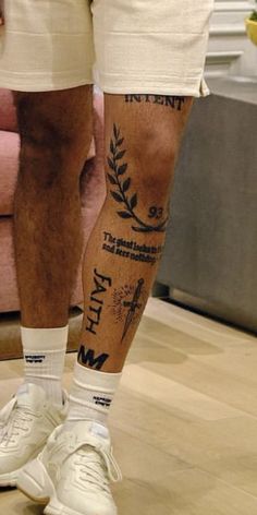 a man's legs with tattoos on them