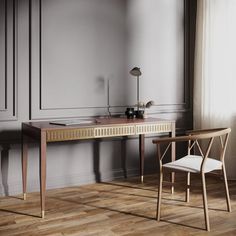 an empty room with a desk, chair and lamp on the floor in front of it