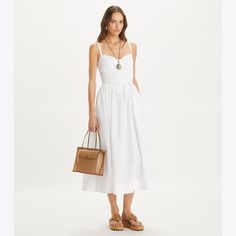 Our broderie anglaise dress is cut from crisp cotton in delicate eyelet embroidery. The sweetheart neckline and fitted bodice accentuate the waist, while gentle pleats fall to a voluminous ankle-length skirt. Broderie Anglaise Dress, Fitted Knee Length Dress, Anglaise Dress, Wrap Dress Midi, Tory Burch Dress, Ankle Length Skirt, Eyelet Embroidery, White Prom Dress, Resort Dresses